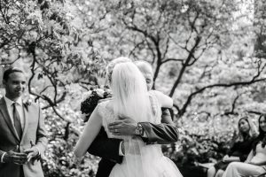 father hugs bride