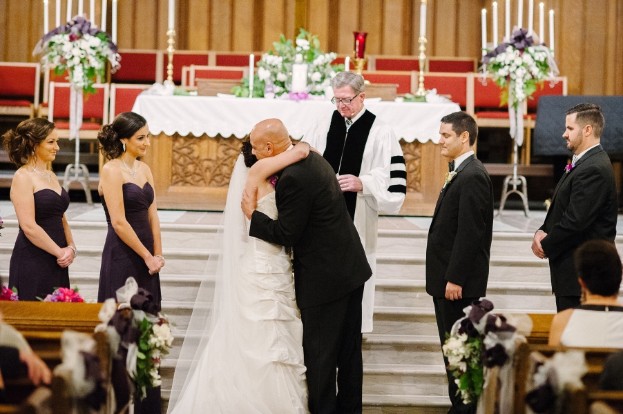 bride and dad hug at altar
